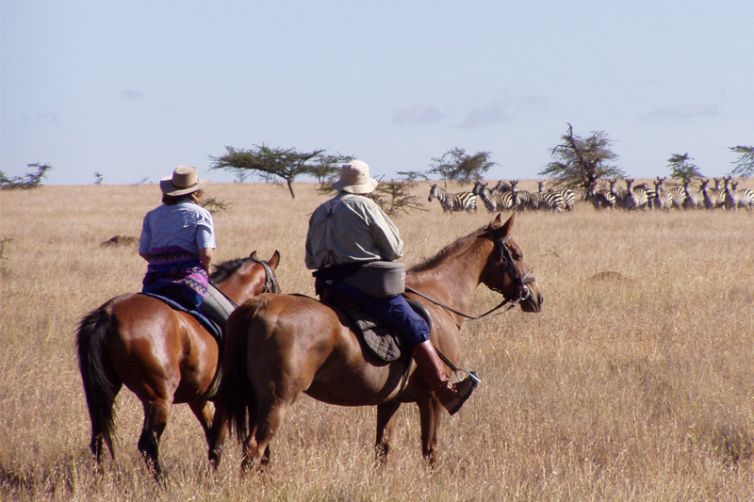 Sosian horse riding with zebra